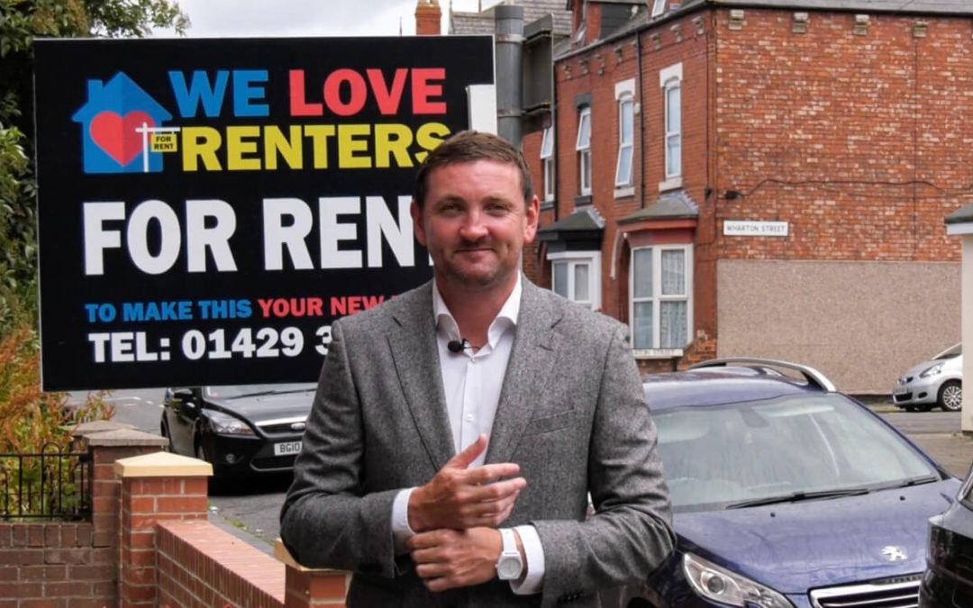 Paul Gough standing in front of a We Love Renters Board outside a property